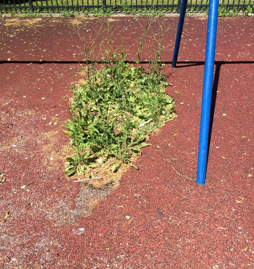 really badly damaged playground rubber surface